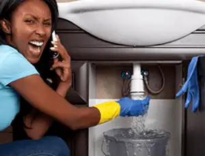 Emergency plumbing repair for a leaking sink drain under a bathroom vanity in Lancaster, PA